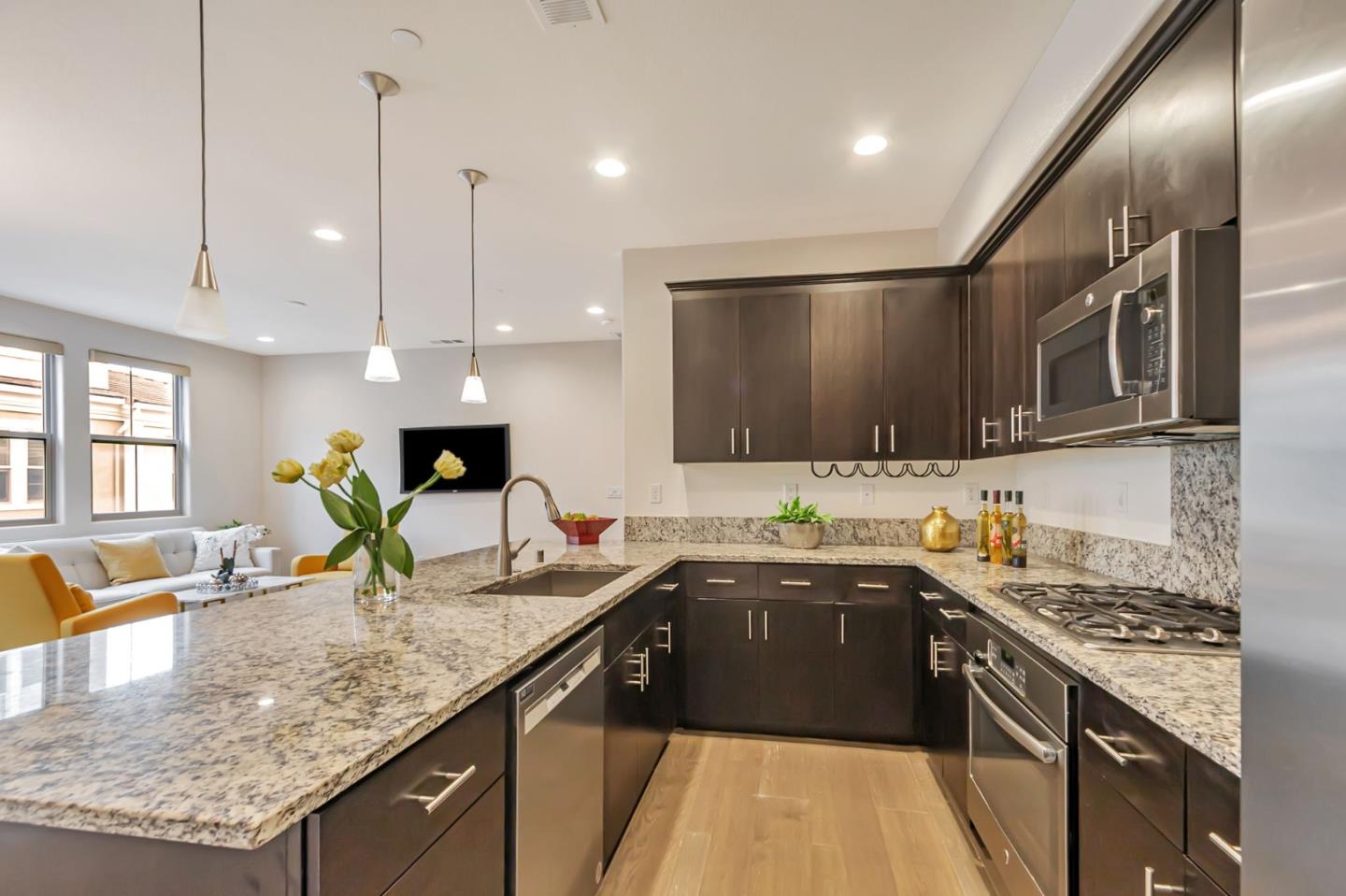 1890 Trento Loop Milpitas, CA 95035 - Photo 7 of 39 a kitchen with stainless steel appliances granite countertop sink stove and refrigerator
