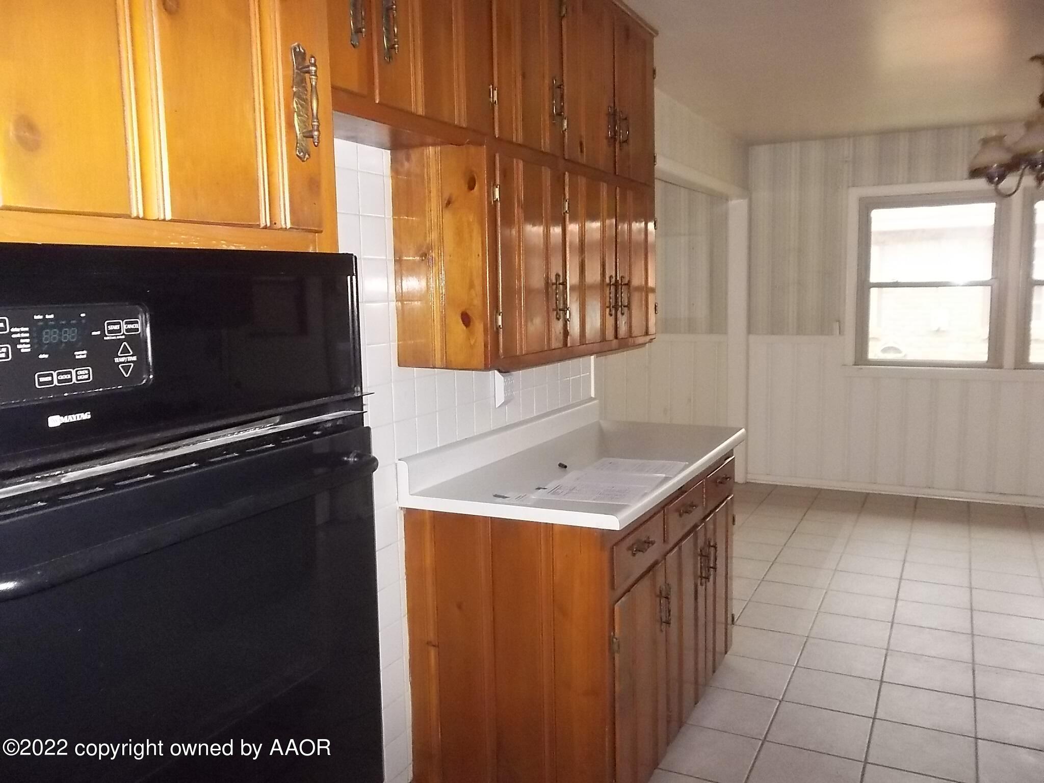 4010 Tucson Drive Amarillo, TX 79109 - Photo 13 of 23 a kitchen with a sink a stove and a microwave