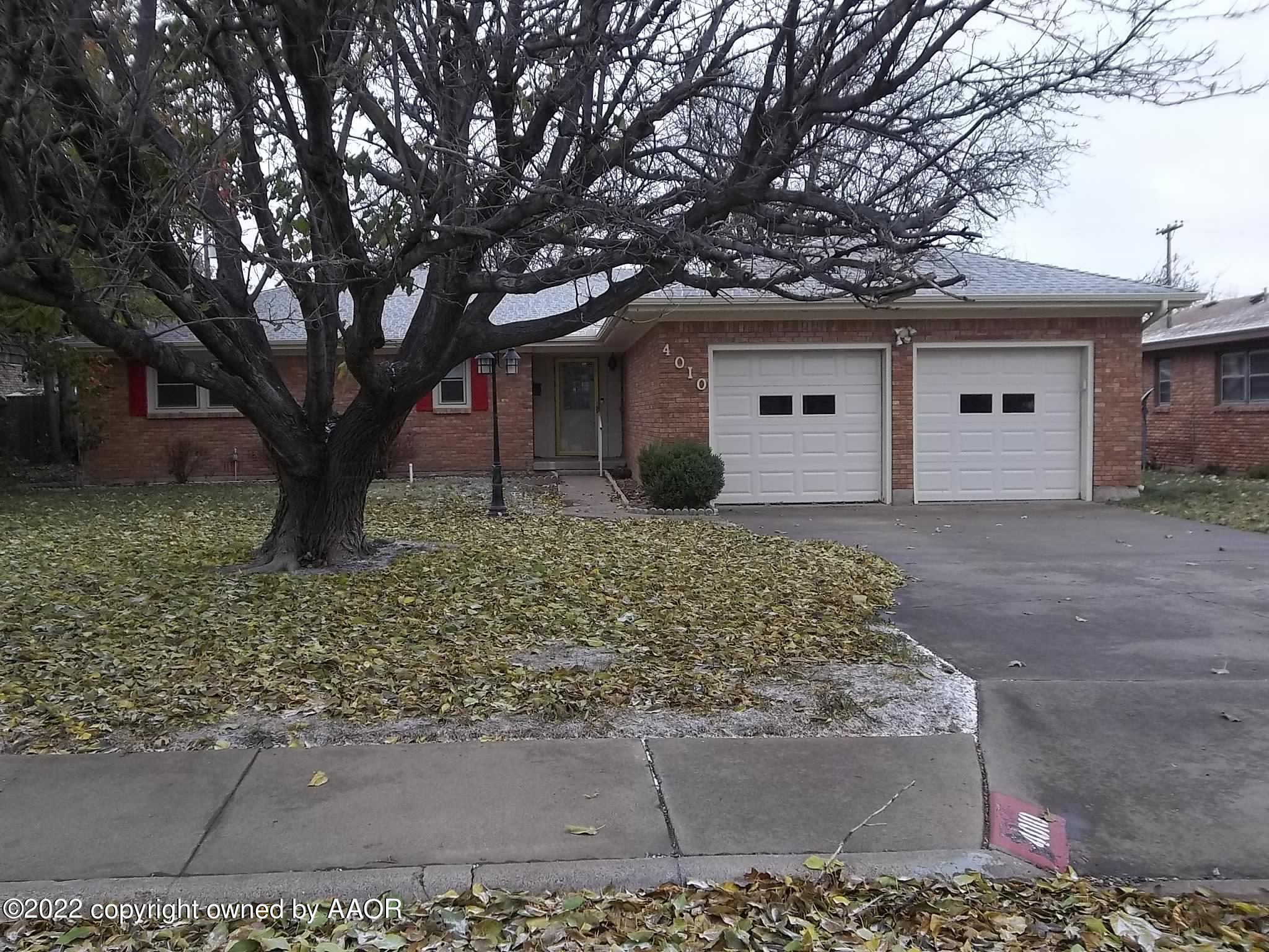 4010 Tucson Drive Amarillo, TX 79109 - Photo 2 of 23 a front view of a house with a yard and garage