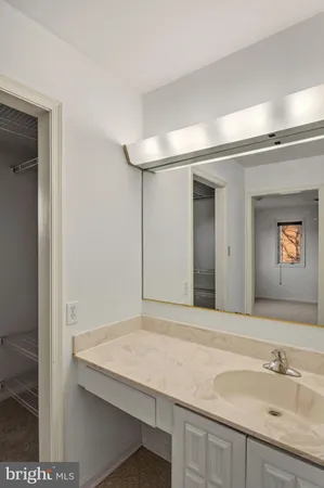 a bathroom with a tub sink and mirror
