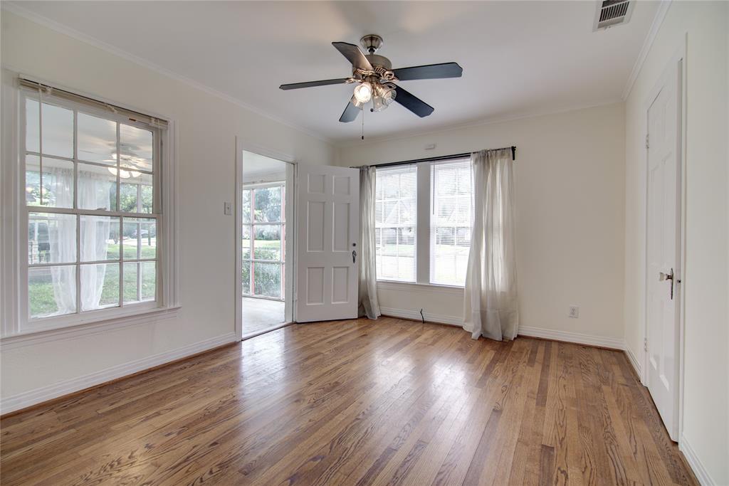 5419 Longview Street Dallas, TX 75206 - Photo 19 of 32 a view of an empty room with wooden floor and a window