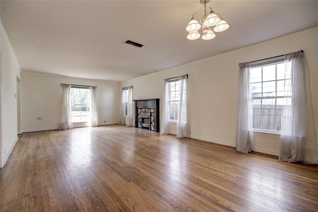5419 Longview Street Dallas, TX 75206 - Photo 4 of 32 a view of an empty room with wooden floor and a window
