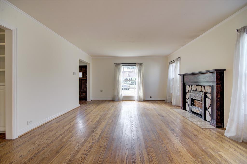 5419 Longview Street Dallas, TX 75206 - Photo 5 of 32 an empty room with wooden floor and windows