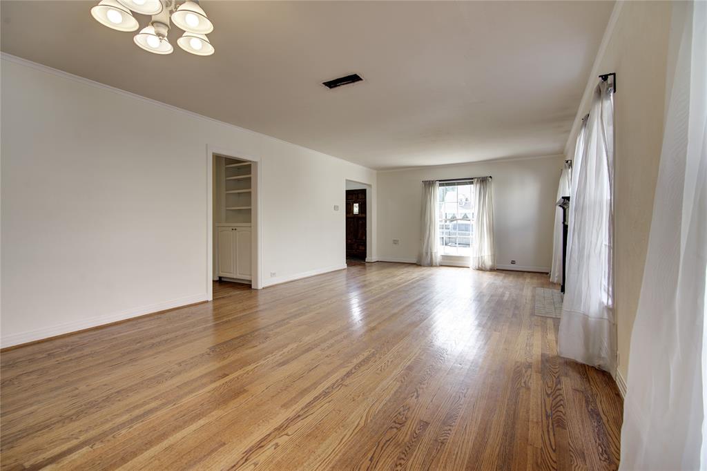 5419 Longview Street Dallas, TX 75206 - Photo 7 of 32 a view of an empty room with wooden floor and a window