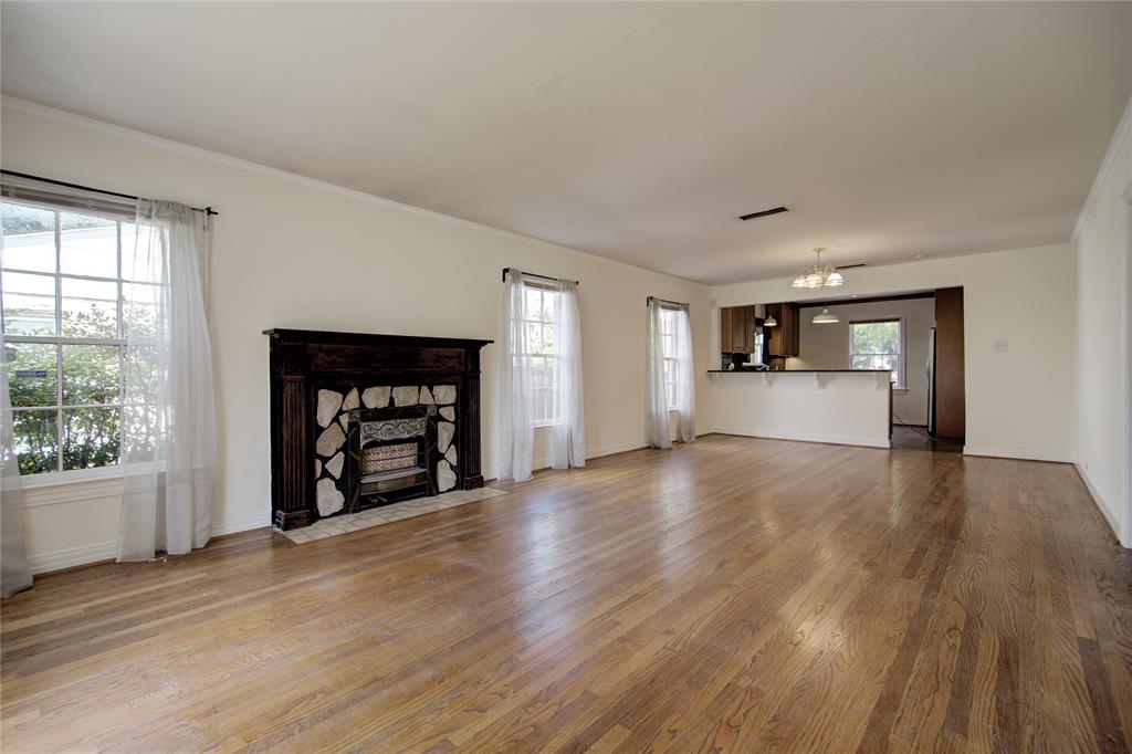 5419 Longview Street Dallas, TX 75206 - Photo 9 of 32 a view of empty room with wooden floor and fireplace