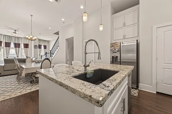 a kitchen with stainless steel appliances granite countertop a sink stove and cabinets