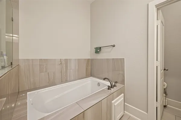 a bathroom with a bathtub and shower