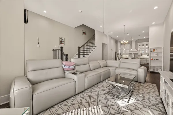 a living room with furniture and a chandelier
