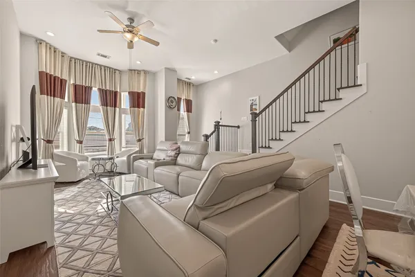 a living room with furniture a flat screen tv and a table