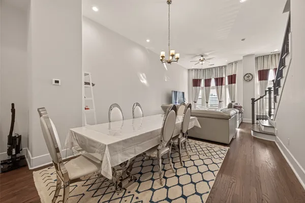 a kitchen with kitchen island granite countertop a sink cabinets and wooden floor