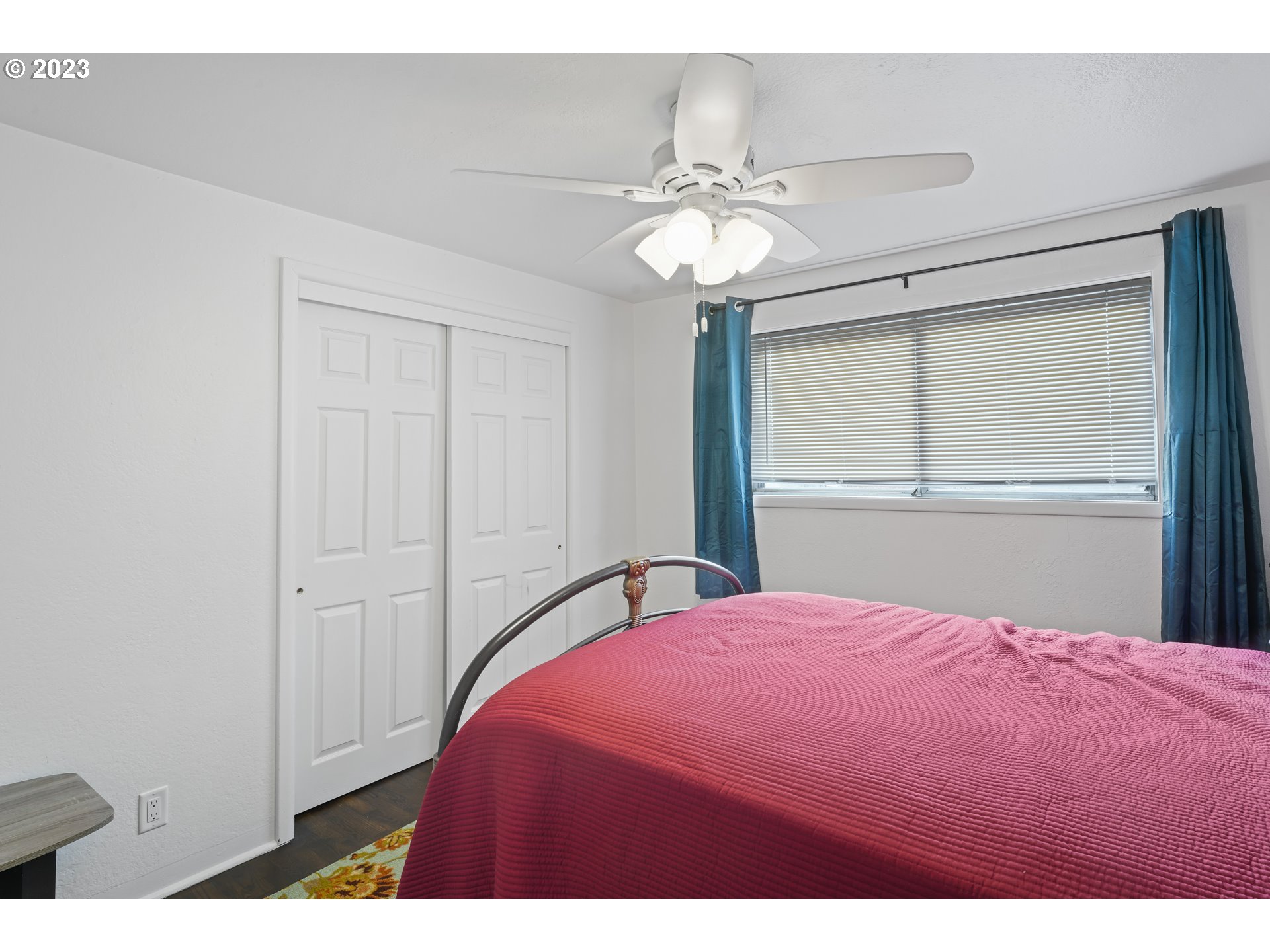1138 18th Street Springfield, OR 97477 - Photo 13 of 32 a bedroom with a bed and a chandelier