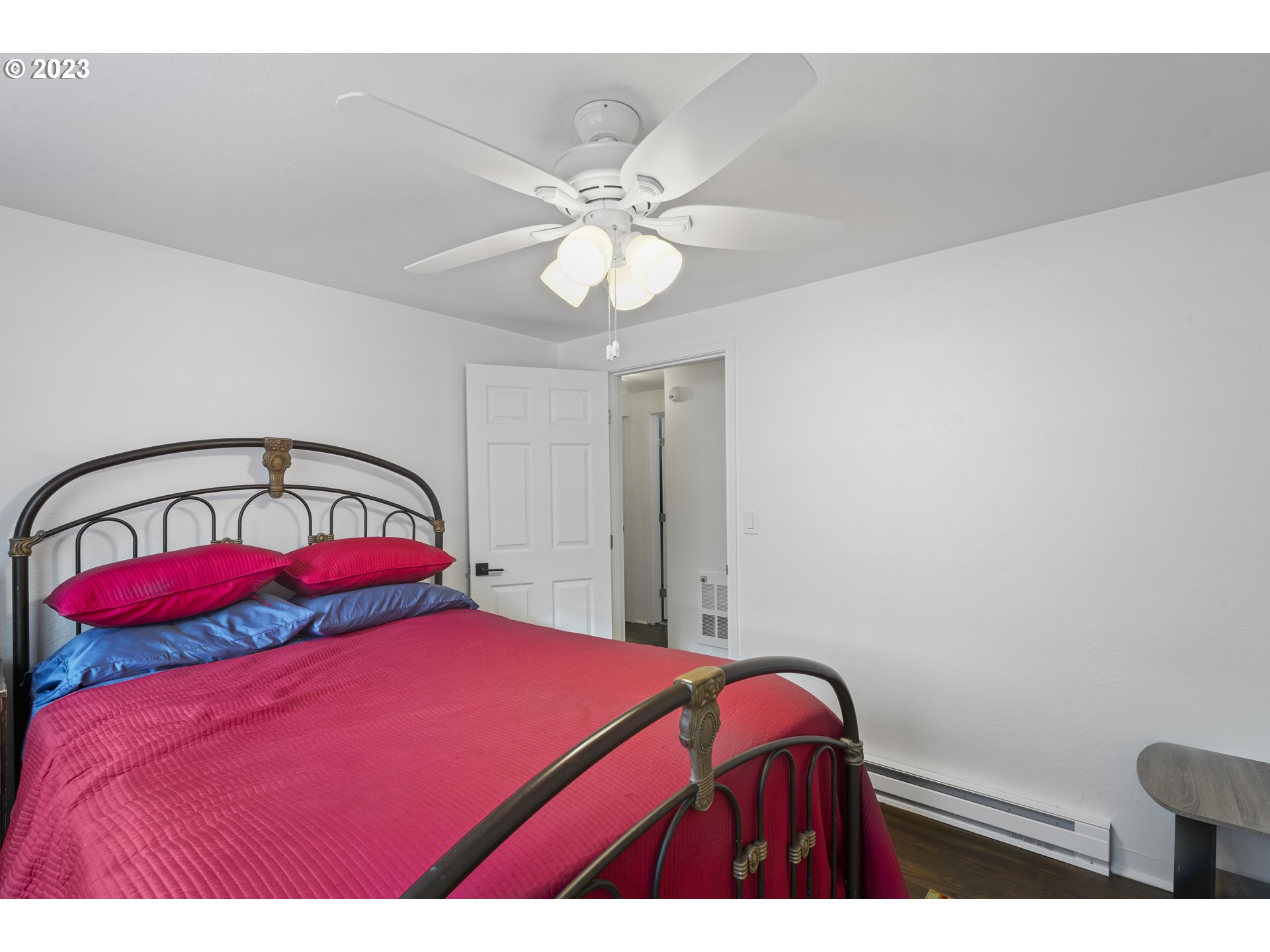 1138 18th Street Springfield, OR 97477 - Photo 14 of 32 a bedroom with a bed and a chandelier