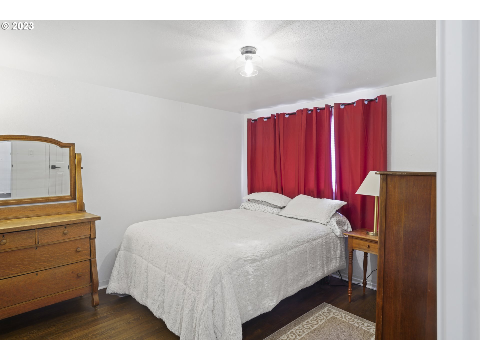 1138 18th Street Springfield, OR 97477 - Photo 15 of 32 a bedroom with a bed a dresser and a mirror