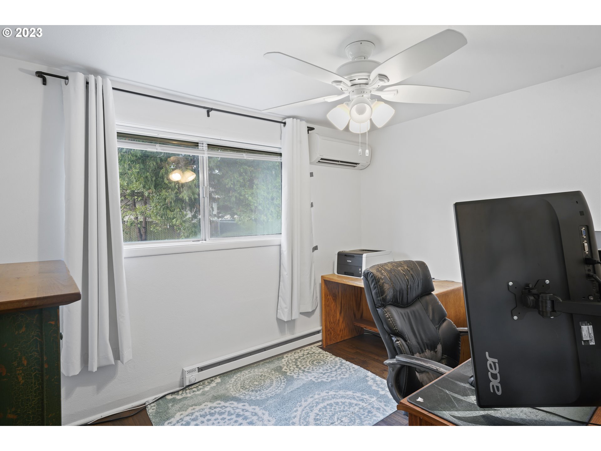 1138 18th Street Springfield, OR 97477 - Photo 17 of 32 a workspace with wooden floor and windows