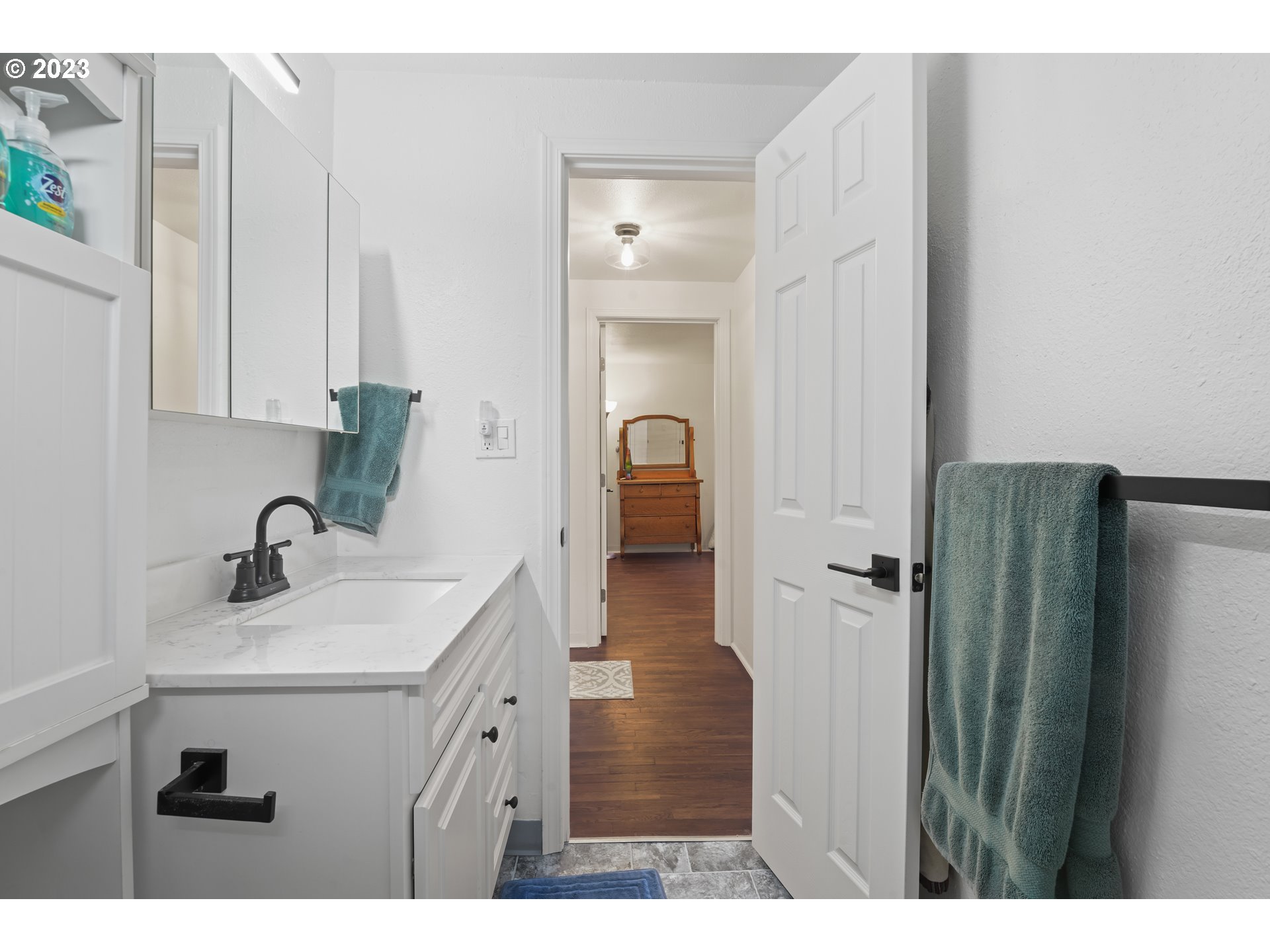 1138 18th Street Springfield, OR 97477 - Photo 20 of 32 a bathroom with a sink vanity and a mirror
