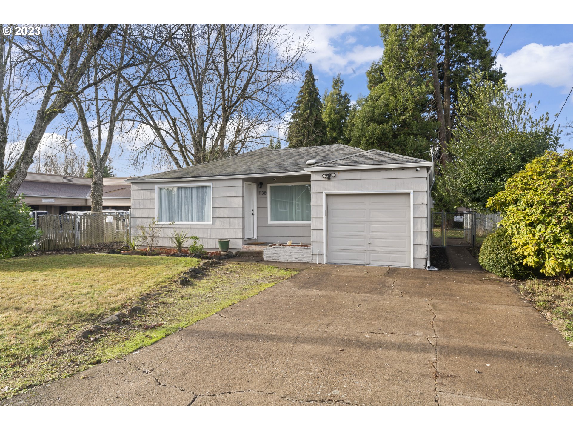 1138 18th Street Springfield, OR 97477 - Photo 2 of 32 a view of a house with a yard and garage