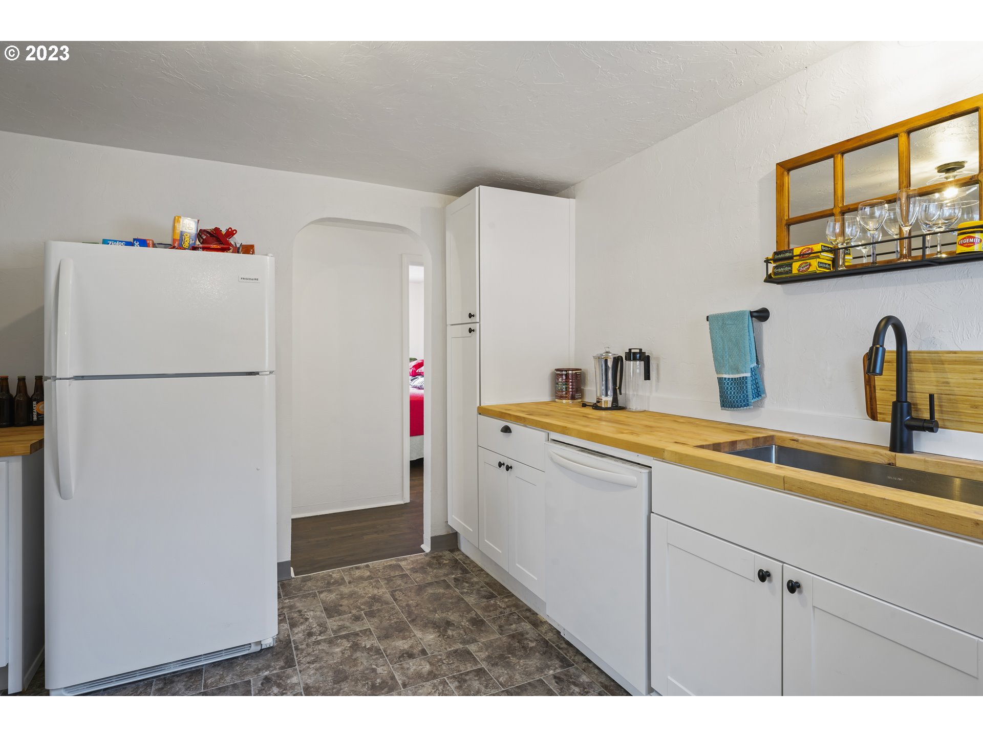 1138 18th Street Springfield, OR 97477 - Photo 9 of 32 a kitchen with a sink and refrigerator