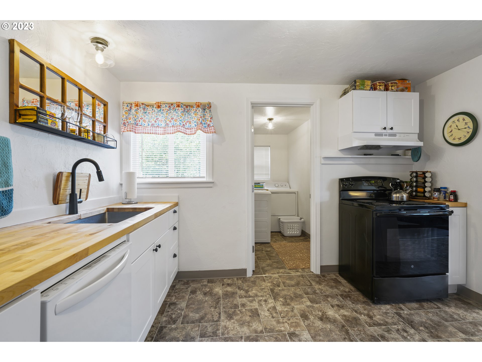 1138 18th Street Springfield, OR 97477 - Photo 10 of 32 a kitchen with stainless steel appliances granite countertop a stove a sink and a refrigerator