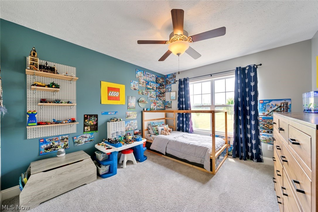 6517 Stone Road Medina, OH 44256 - Photo 25 of 47 Carpeted bedroom featuring a textured ceiling and ceiling fan