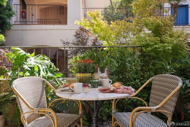 a living room with furniture fireplace and floor to ceiling windows