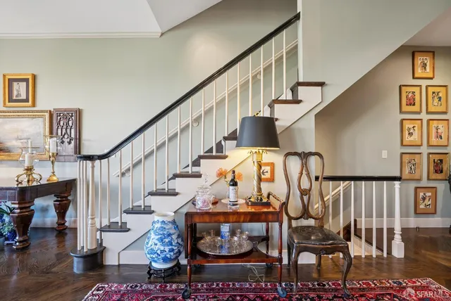a balcony with a potted plant and outdoor seating