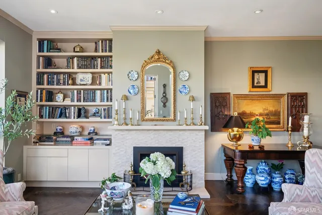 a living room with furniture a rug and a bookshelf