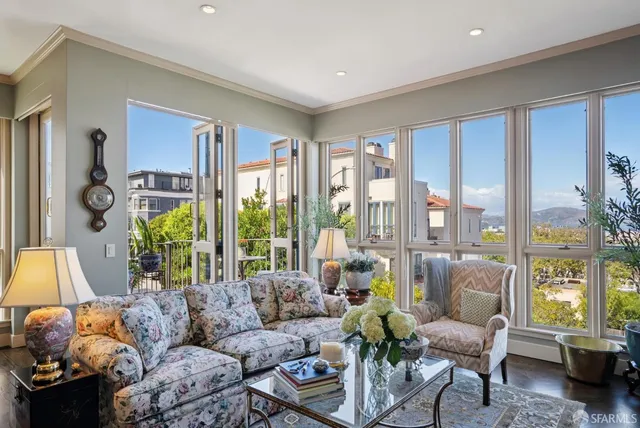 a living room with furniture piano and wooden floor