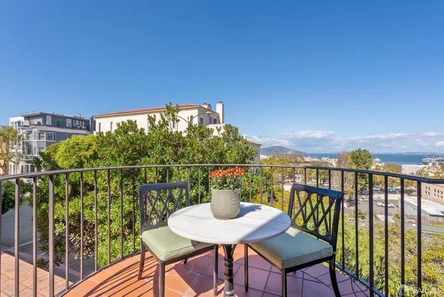 a living room with furniture fireplace and a large window