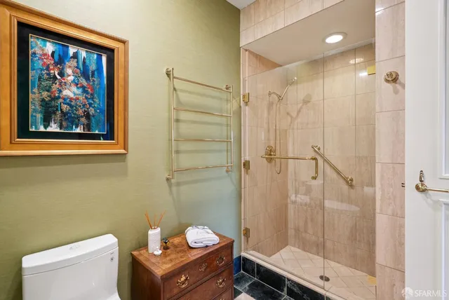 a roof deck with couch and potted plants