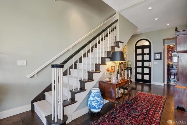 a bathroom with a granite countertop double vanity sink and a mirror