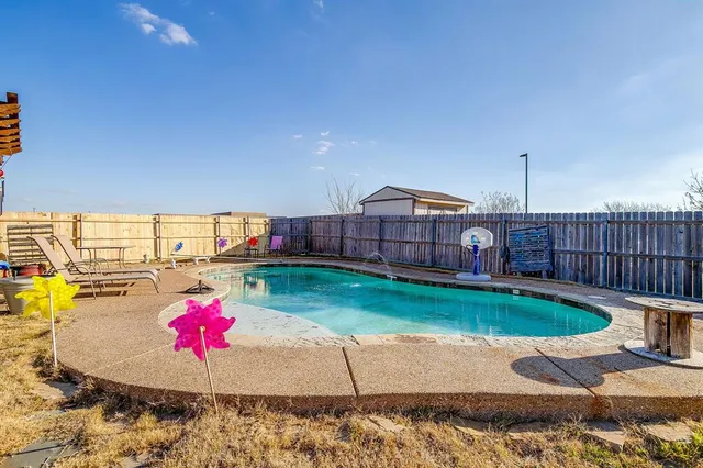 a view of a backyard with sitting area