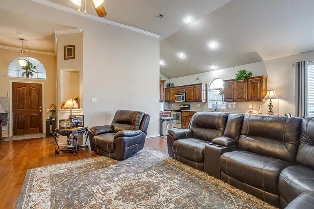 a living room with furniture and a wooden floor