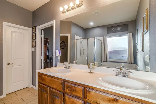 a bathroom with a double vanity sink and a mirror