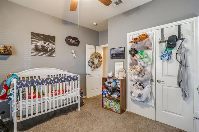 a bedroom with a bed and a white door