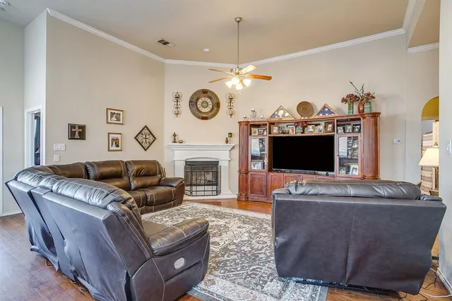 a living room with furniture a fireplace and a flat screen tv