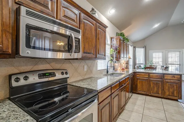 a kitchen with a stove microwave and sink
