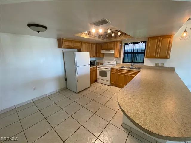 a white refrigerator freezer sitting inside of a kitchen