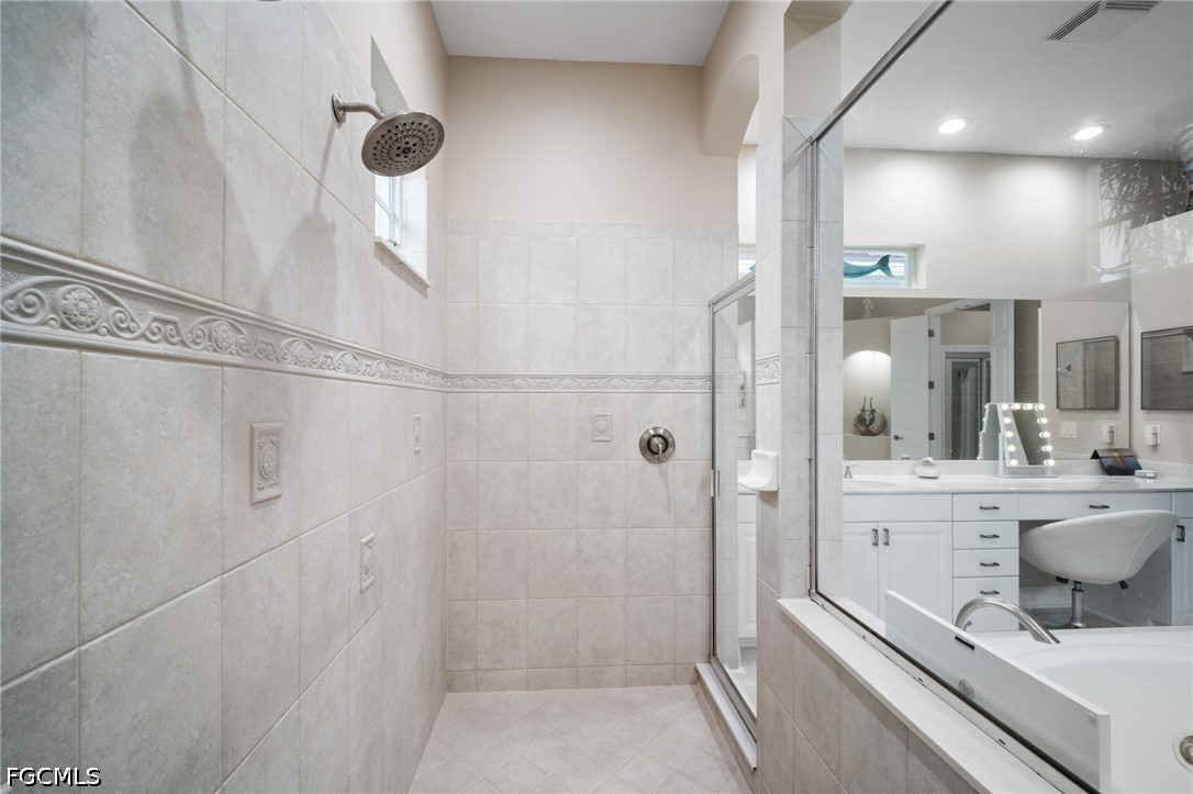 9042 Bronco Court Naples, FL 34113 - Photo 20 of 50 a bathroom with a shower and a sink