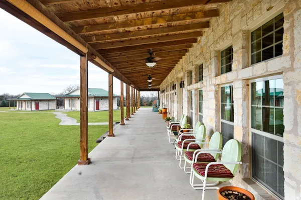 a front view of a house with outdoor seating
