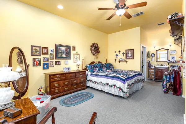 a living room with furniture and a baby crib
