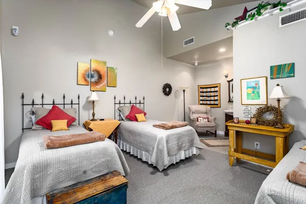 a bedroom with bed and a chandelier