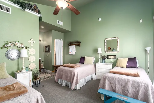 a bathroom with a granite countertop sink a toilet and a mirror