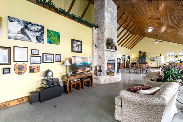 a living room with fireplace furniture and a floor to ceiling window
