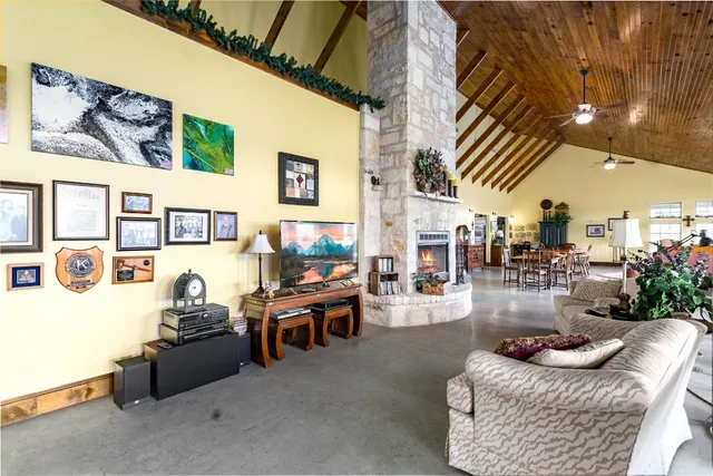 a living room with fireplace furniture and a floor to ceiling window