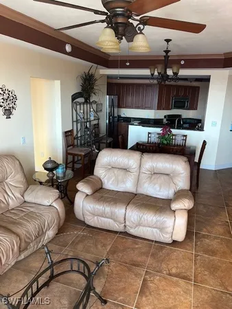 a living room with furniture and kitchen view