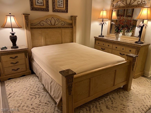 2743 First Street, Unit 804 Fort Myers, FL 33916 - Photo 6 of 11 a bedroom with a bed and a mirror on dresser