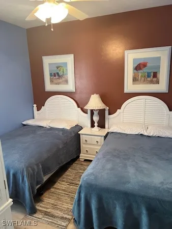 a bedroom with a large bed and a painting on the wall
