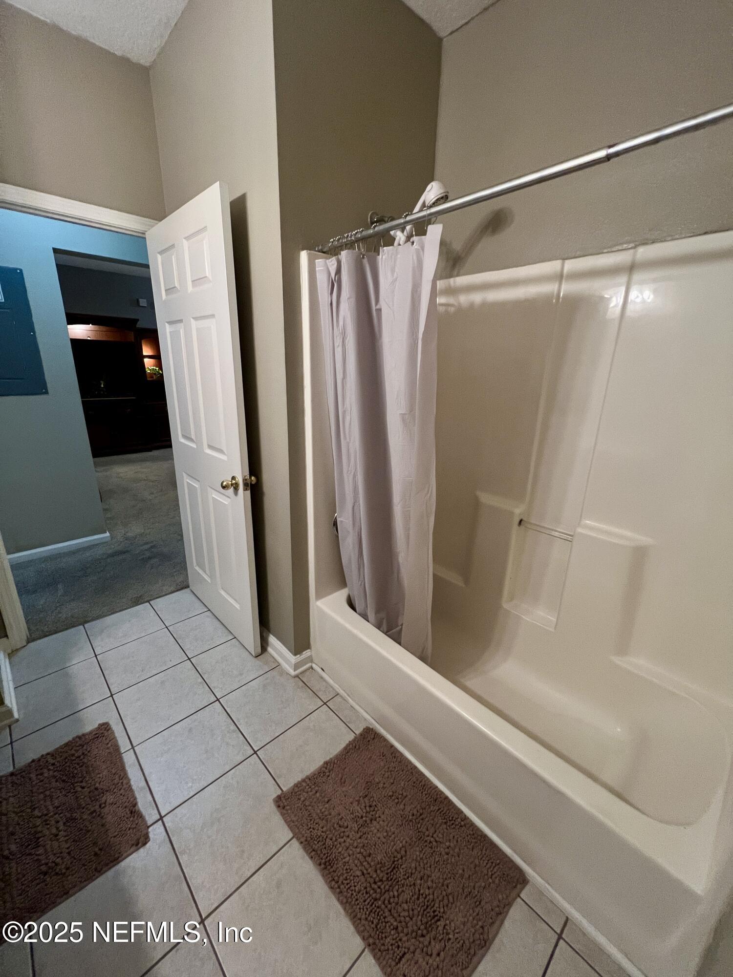 3610 Kirkpatrick Circle, Unit 8 Jacksonville, FL 32210 - Photo 4 of 18 a bathroom with a glass door shower and vanity