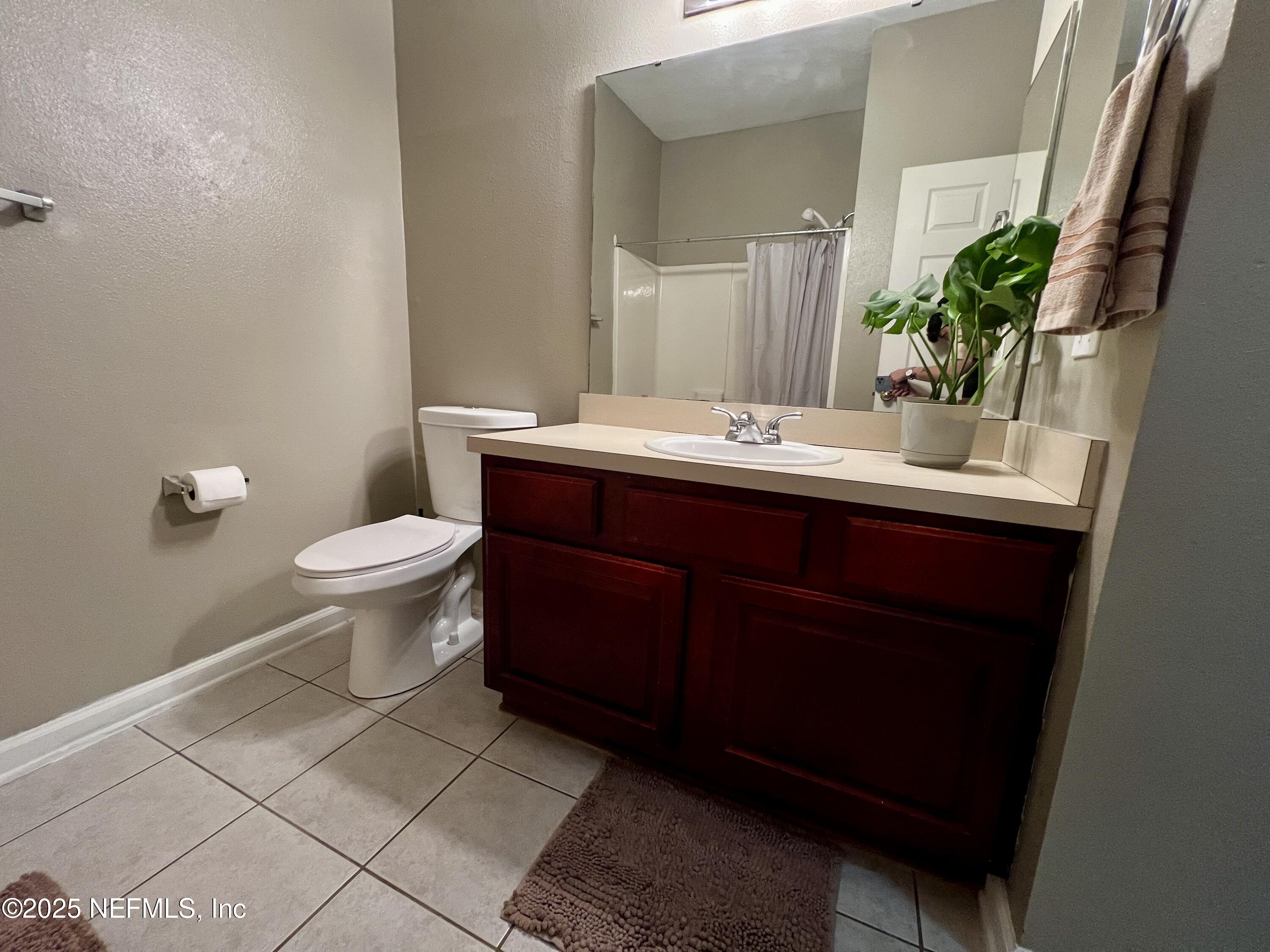 3610 Kirkpatrick Circle, Unit 8 Jacksonville, FL 32210 - Photo 7 of 18 a bathroom with a sink and a mirror