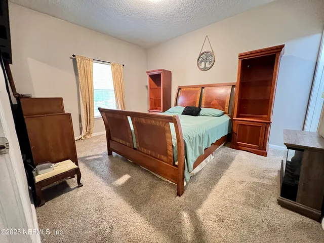a bed room with a bed and a chair
